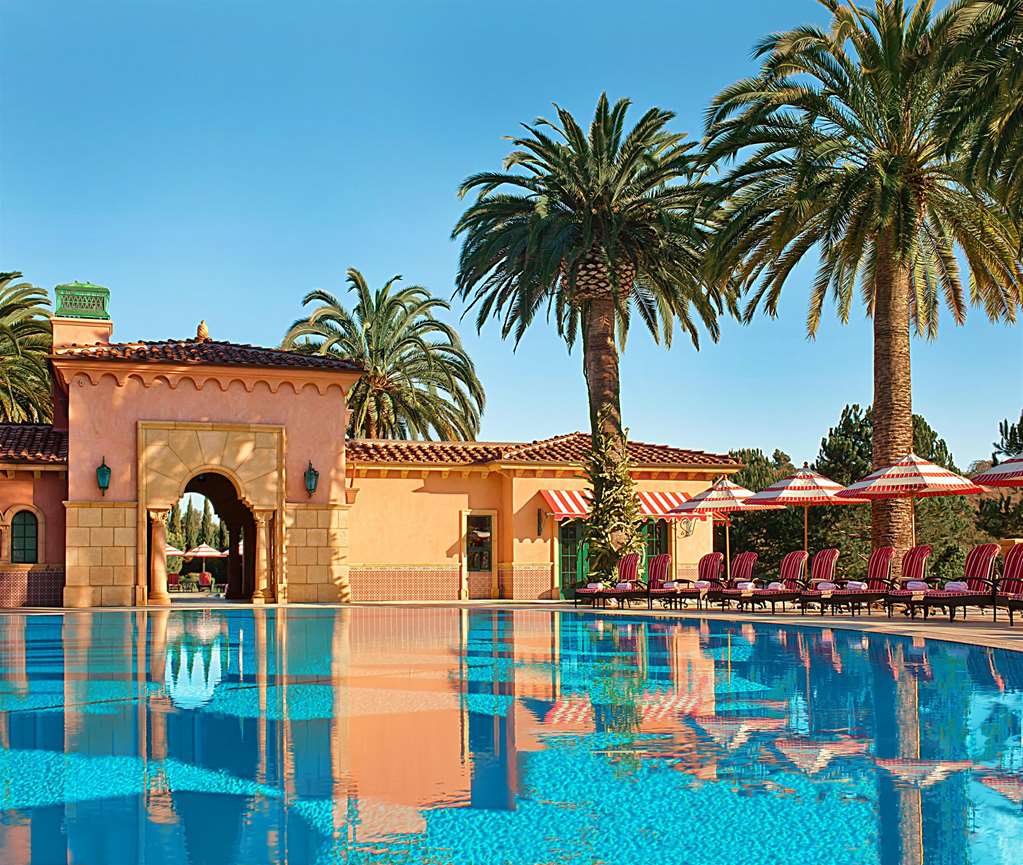 Swimming pool with an arched pavilion and palm trees