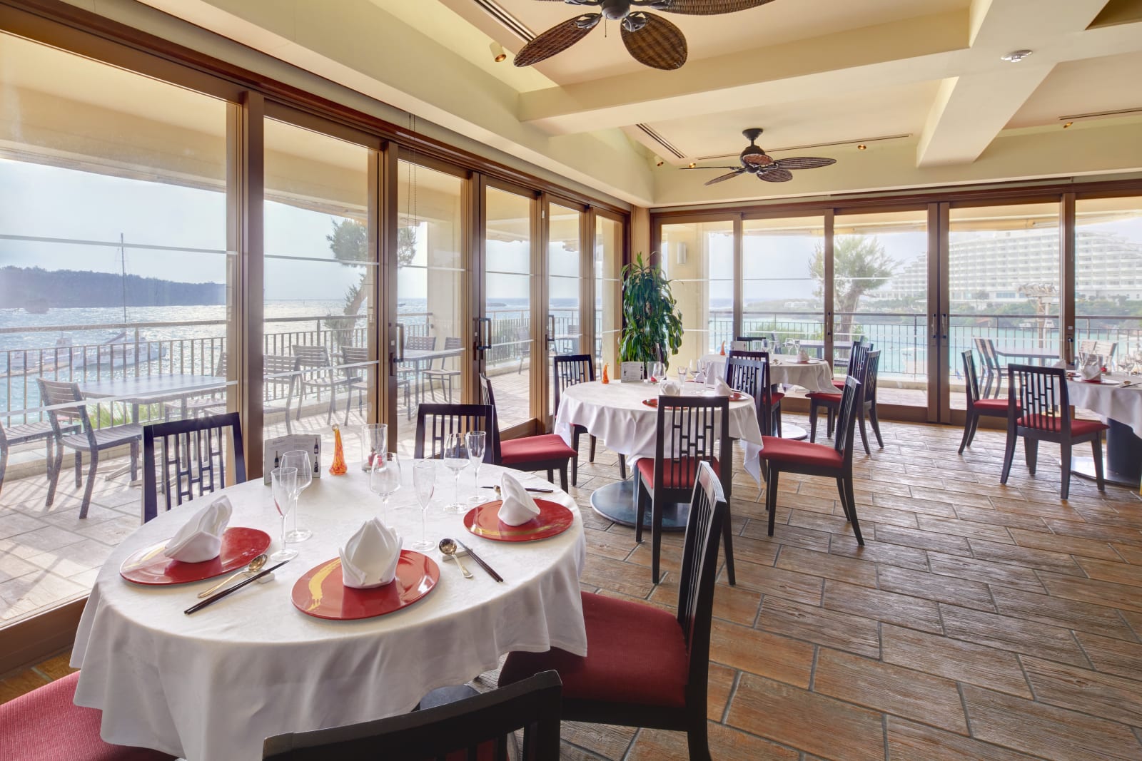 Freestanding beachfront restaurant building with indoor and outdoor seating facing the water