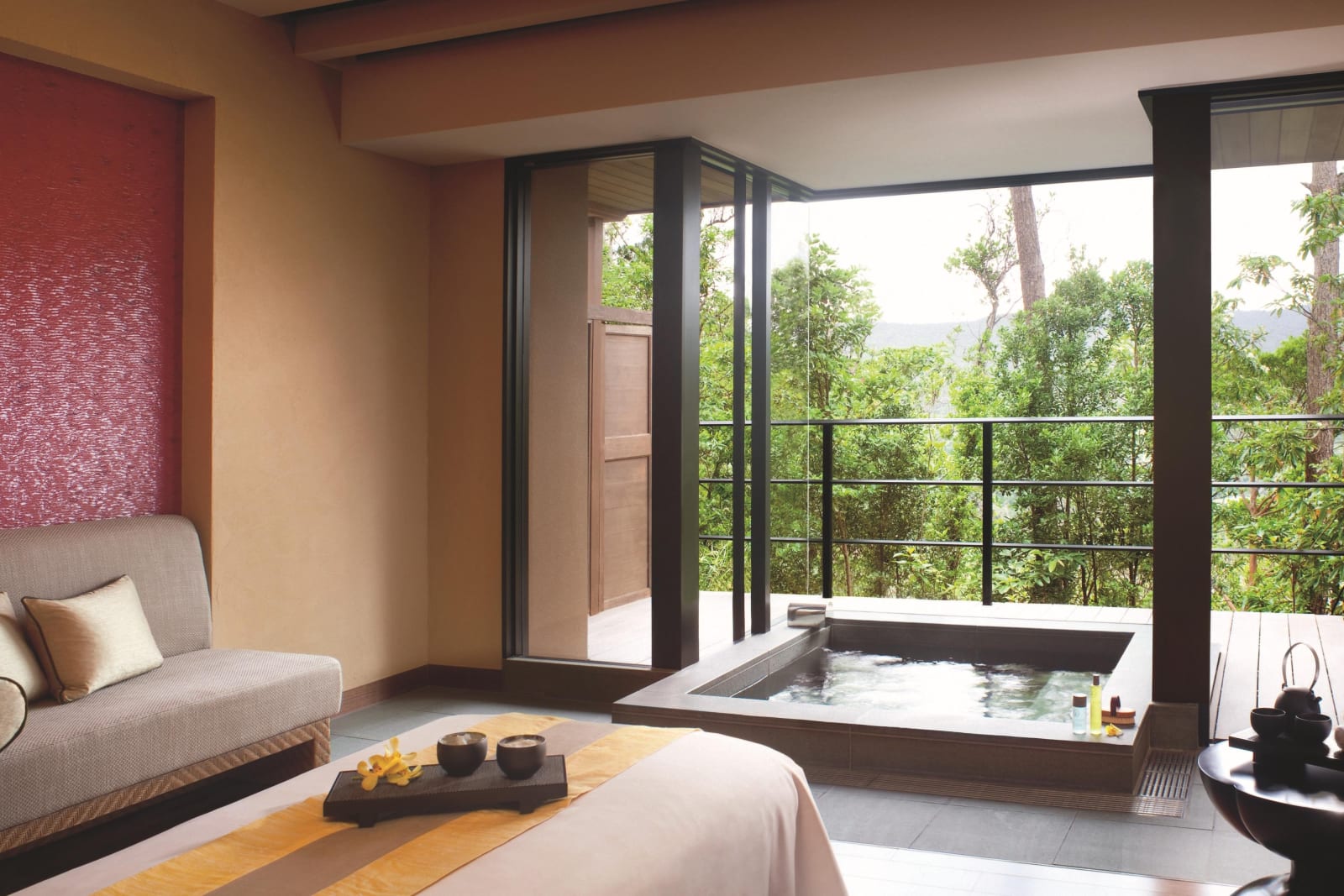 Spa treatment room with two beds and a private bath