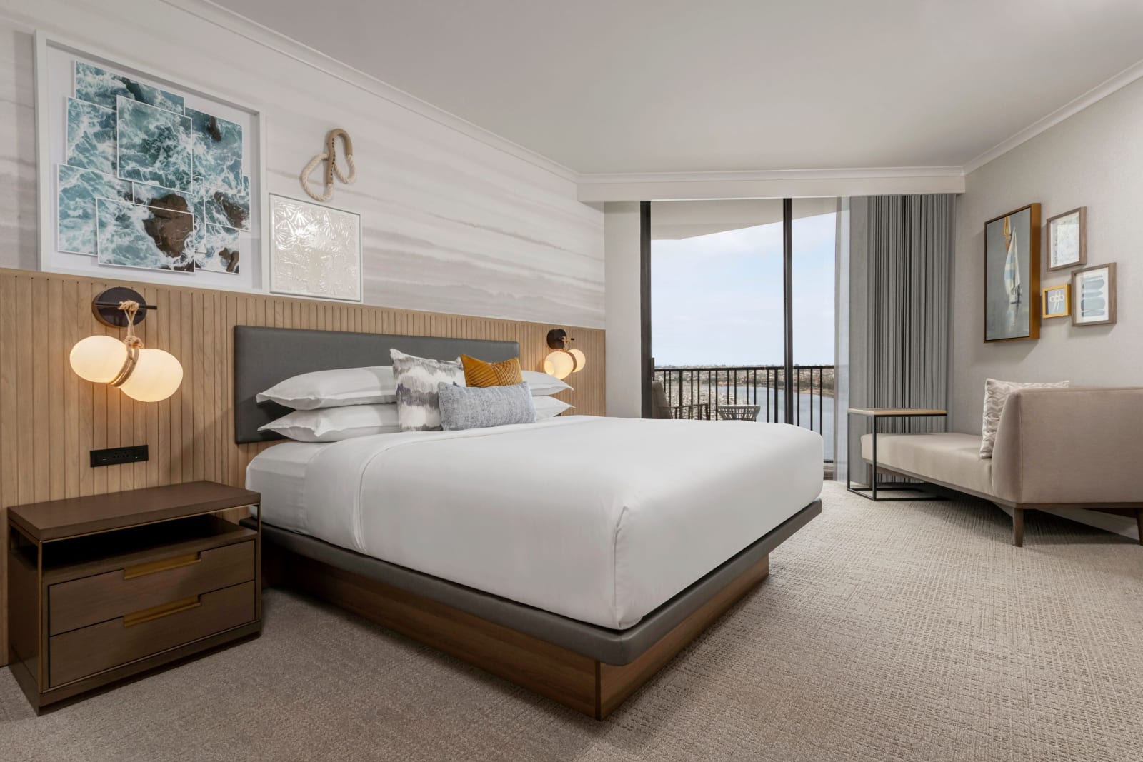 Renovated guest room with pale joinery, modern lighting and a balcony door