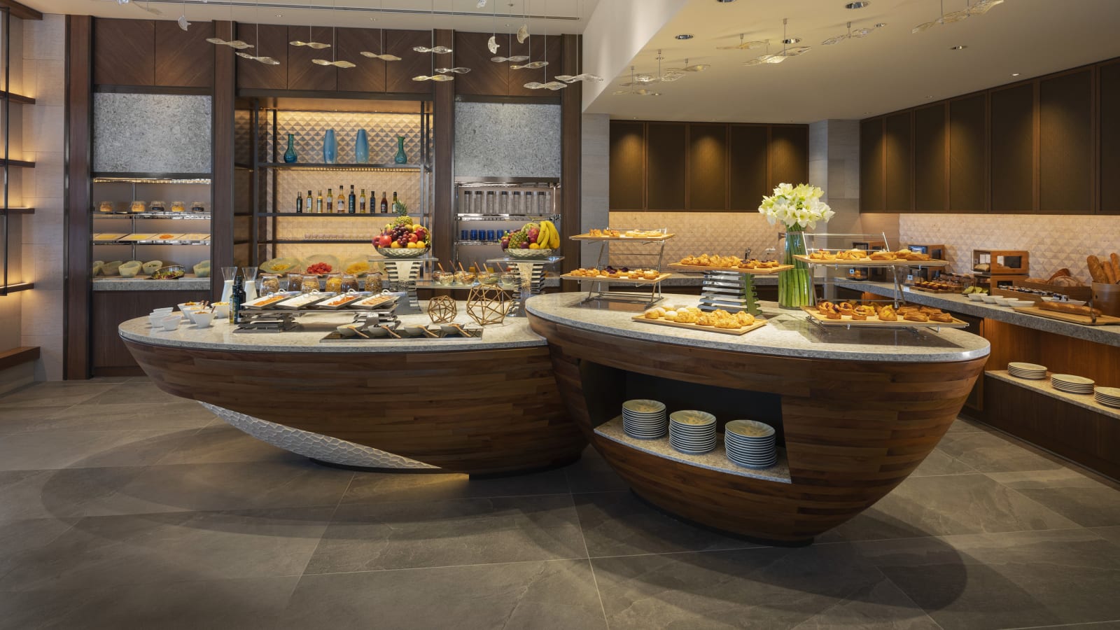 Club lounge interior with wide sea facing windows, a living area and a dining area