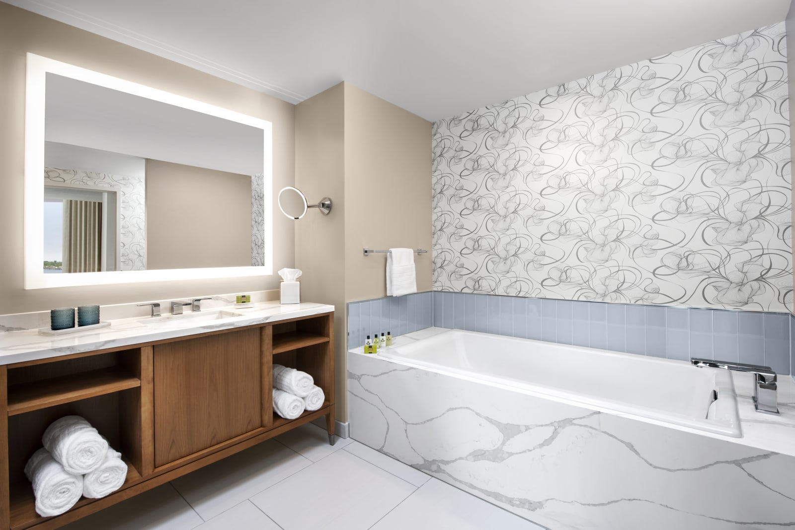 Double vanity bathroom with a marble bathtub