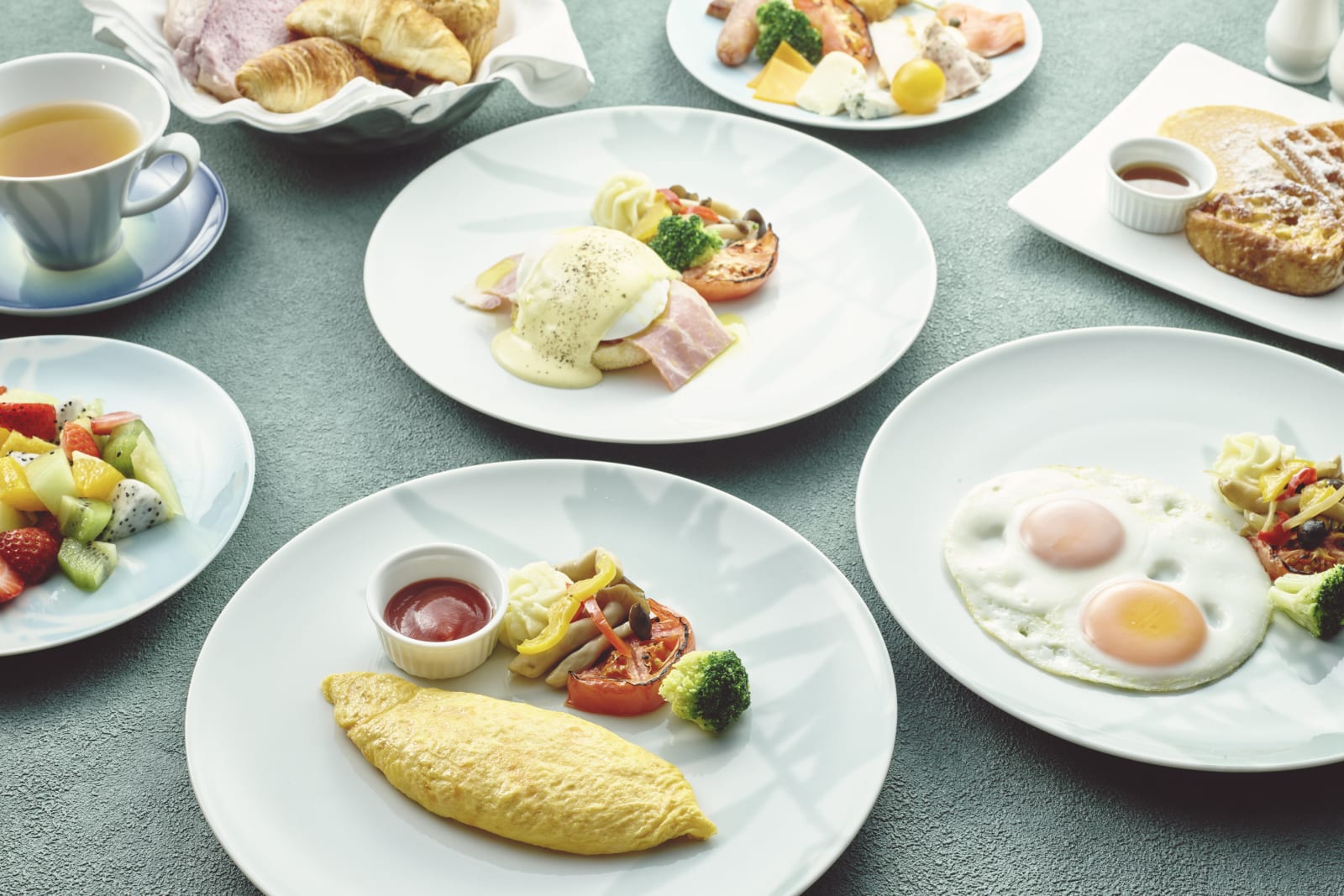 Lounge breakfast setting with a Japanese plated course beside a buffet of salad and bread