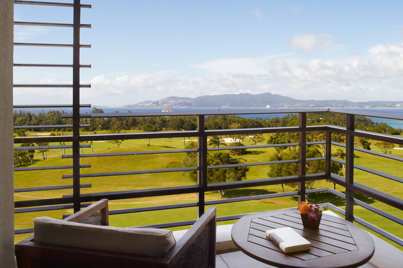 Guest room terrace looking over lawn toward the sea