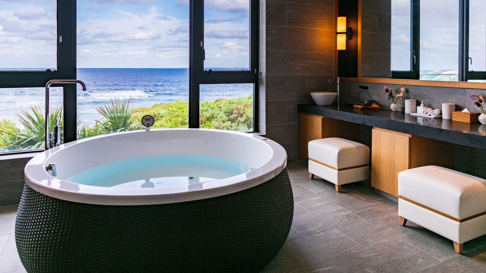 Bathtub set beside a window looking at the sea