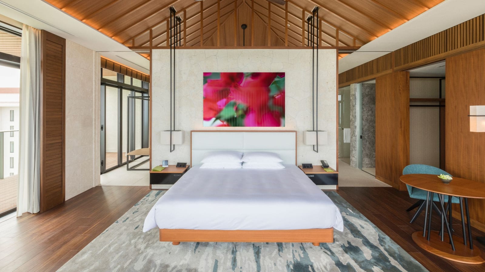 Guest room with two beds and the ocean beyond the window