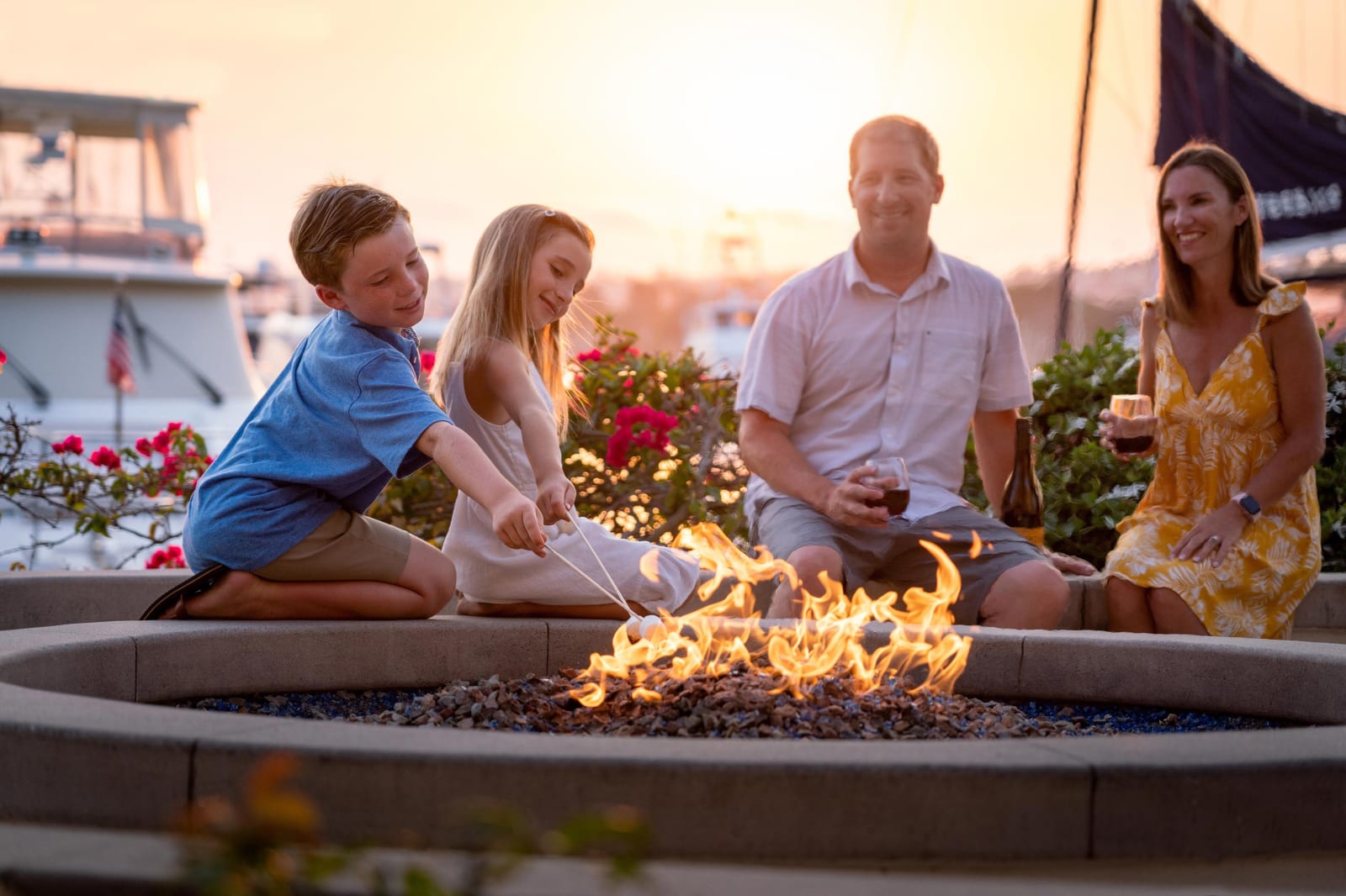 A family gathered around a circular outdoor fire pit
