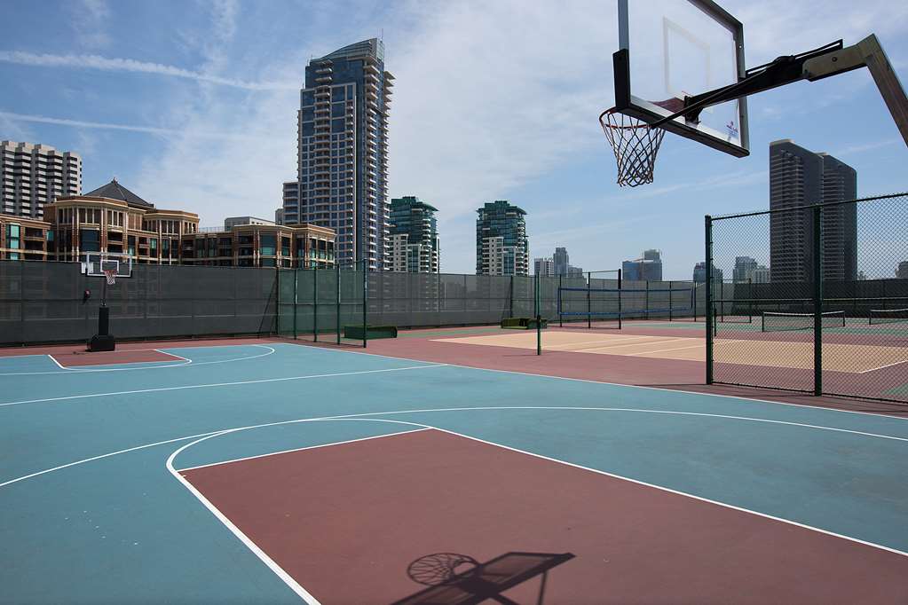 Sport court on the roof deck with downtown towers behind it