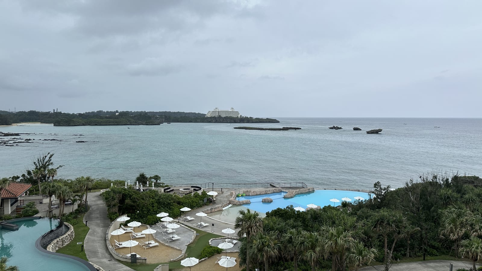 View from the island across the water toward distant coastal buildings