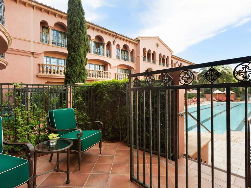 A private patio behind an iron gate with the pool beyond