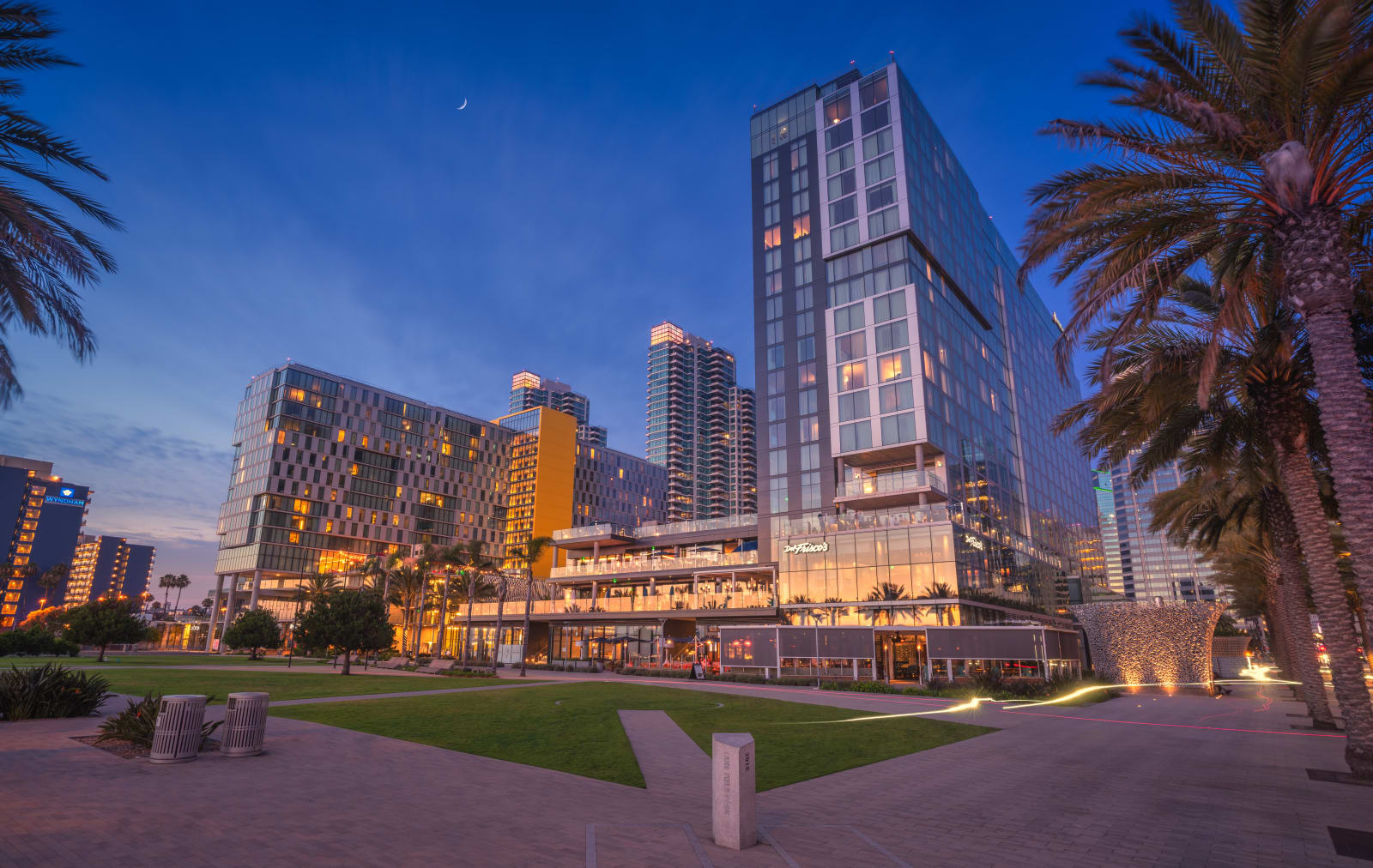 The hotel exterior at dusk with the lawn of Lane Field Park in front