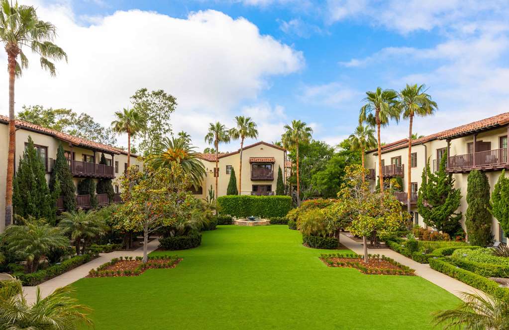 Long central lawn flanked by palms and red tile buildings