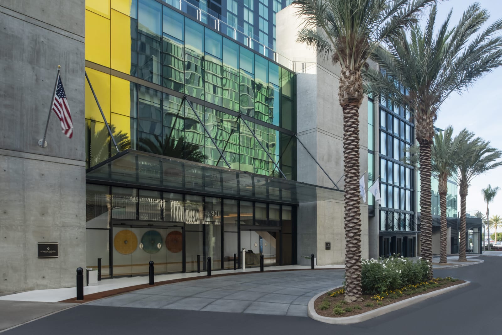 Street level view of the hotel podium facade carrying a large electronic art installation
