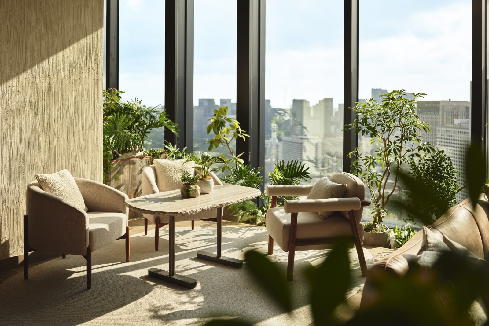 The open living room on the 38th floor, with the Tokyo skyline through the windows