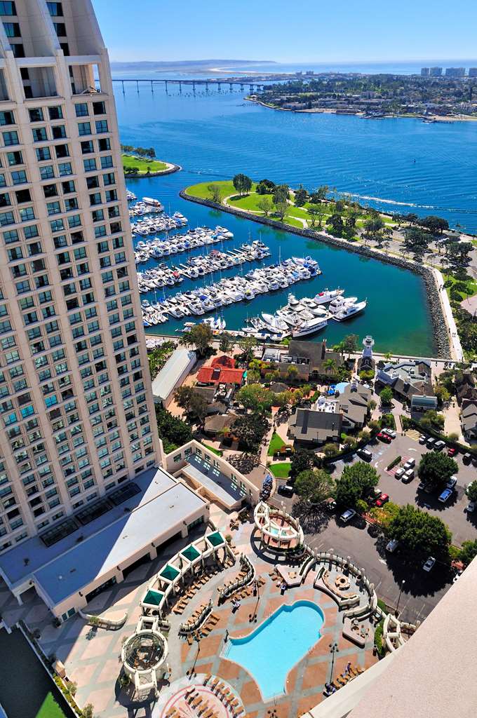 View down from a high floor over the marina, the pool deck and the Coronado Bridge