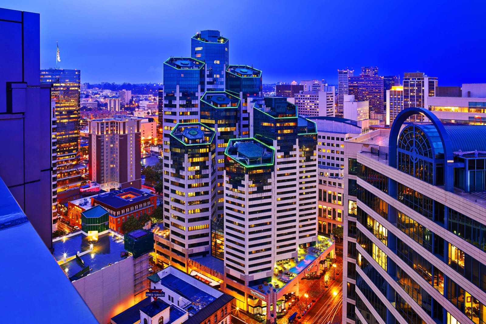 Downtown skyline at night seen from above, towers lit blue