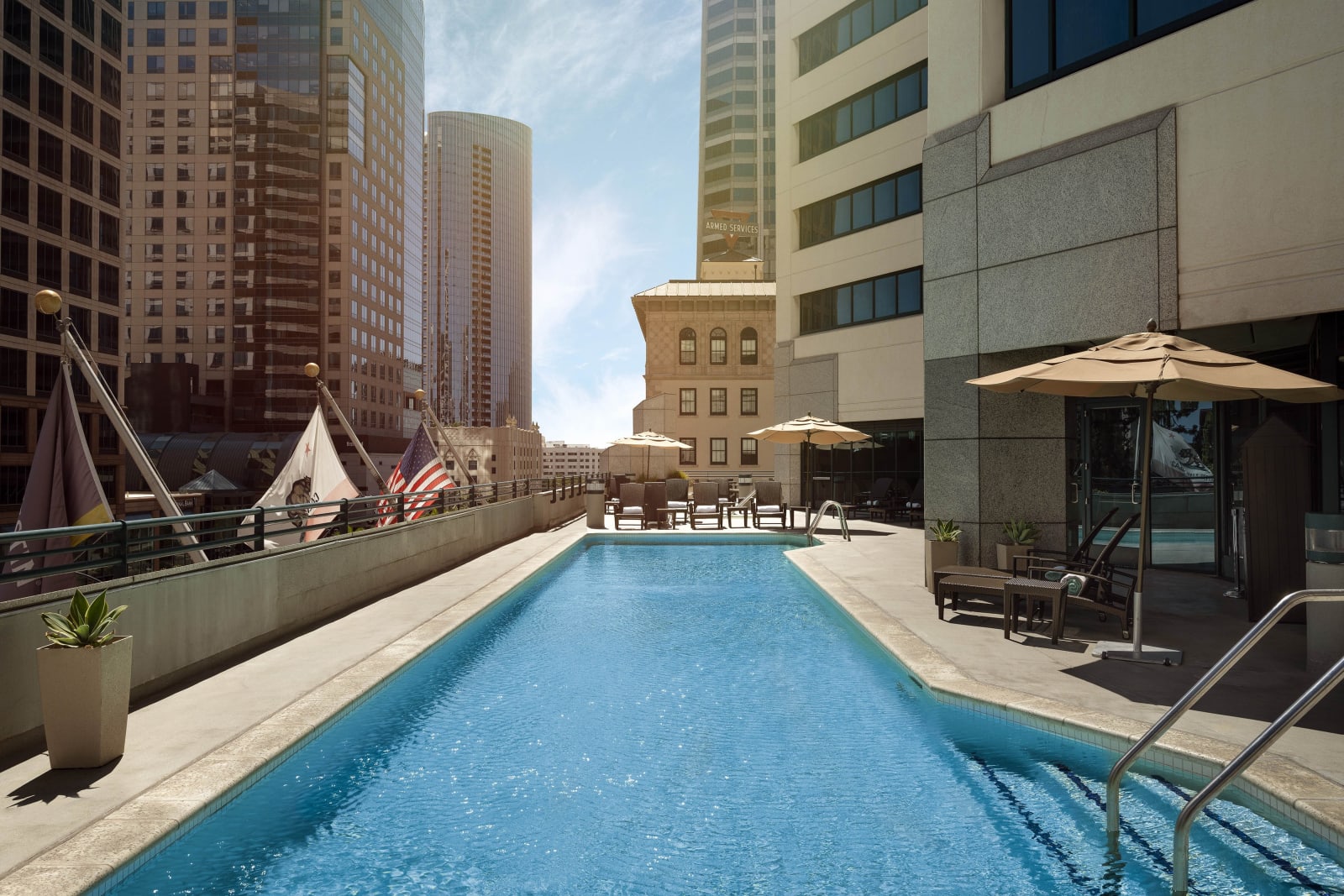 Rooftop swimming pool surrounded by downtown high rise buildings