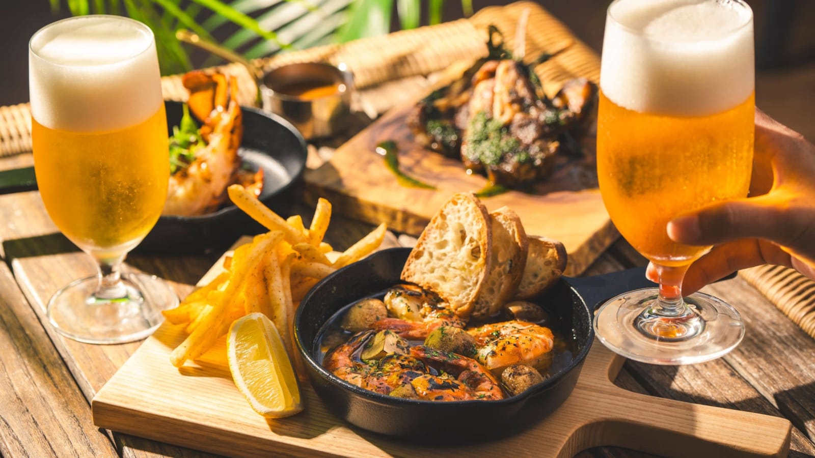 A glass of beer beside an evening plate
