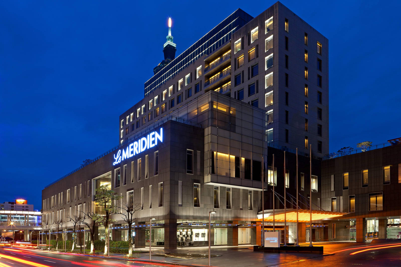 Le Meridien Taipei at night, with Taipei 101 in the distance