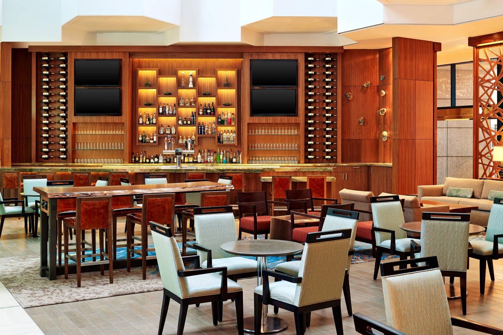 Bar interior with a timber bottle wall and high stools
