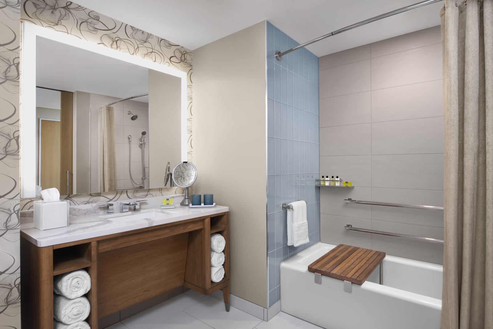 Accessible bathroom with a roll-in shower, fold-down seat and grab bars