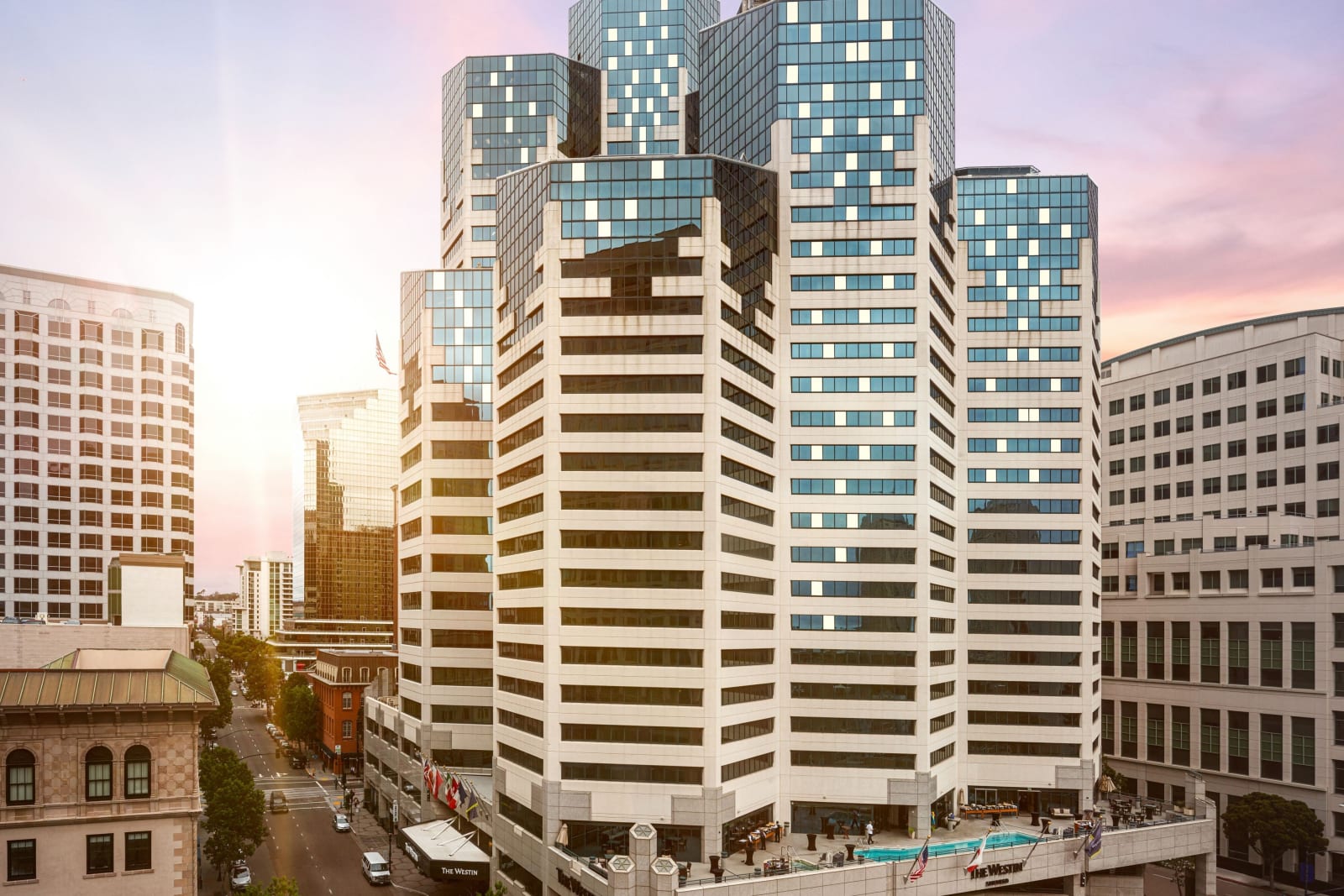 Downtown blocks at dusk with a white hotel tower at the centre