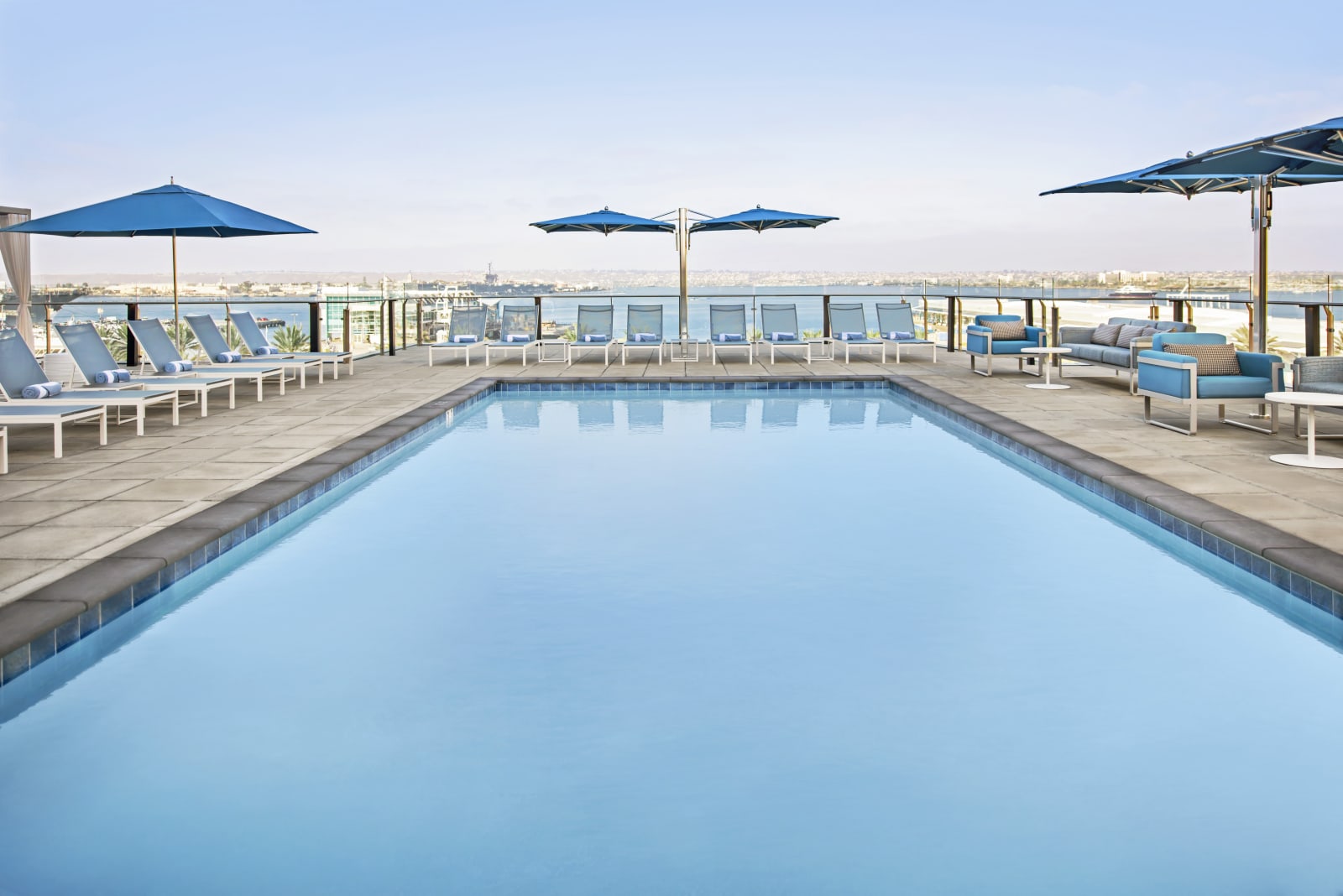 Outdoor pool on the fourth floor with umbrellas and loungers
