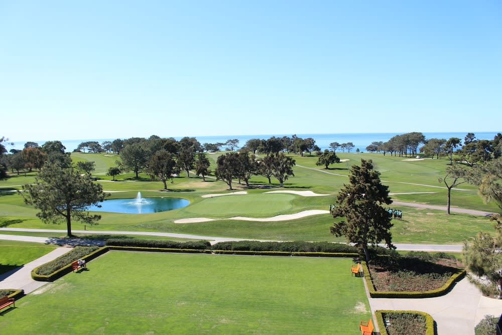 Golf green and pond with the Pacific Ocean beyond
